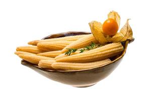 Baby corn in a bowl on white background photo