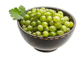 Gooseberries in a bowl on white background photo