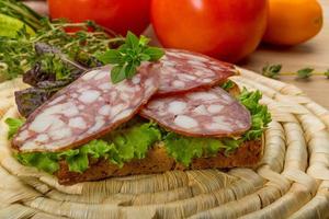 Salami on wooden plate photo