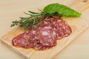 Sliced salami on a board photo