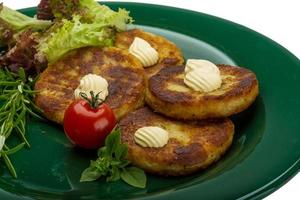 Hash browns on the plate and white background close up view photo