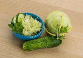 Kohlrabi salad on wooden background photo