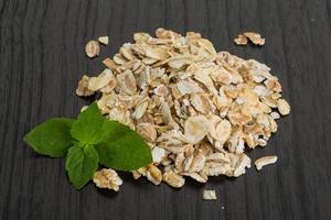 Raw oats on wooden background photo