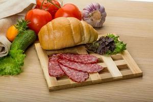 Salami on wooden plate photo