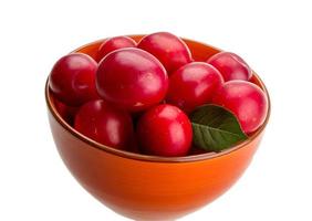 Damson plum in a bowl on white background photo