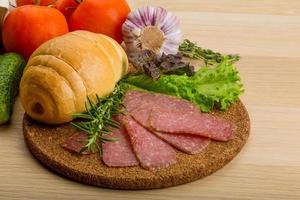 Salami on wooden plate photo