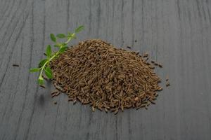 Caraway on wooden background photo