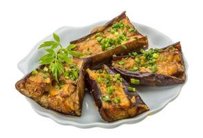 Grilled eggplant on the plate and white background photo