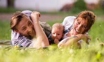 hipster family relaxing in park photo