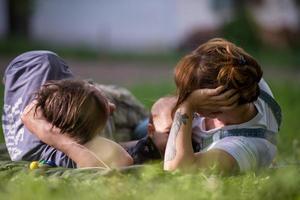 hipster family relaxing in park photo