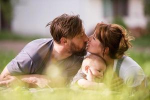 hipster family relaxing in park photo