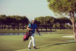 golfer  walking and carrying bag photo