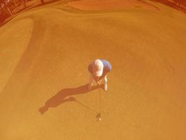 top view of golf player hitting shot photo