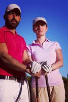 portrait of couple on golf course photo