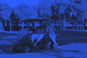 couple in buggy on golf course photo