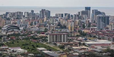 ariel panoramic view of old city and skyscrapers with the sea from the mountains photo