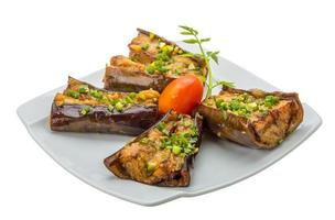 Grilled eggplant on the plate and white background photo