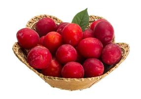 Damson plum in a basket on white background photo