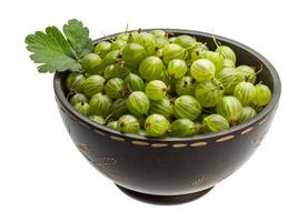 Gooseberries in a bowl on white background photo