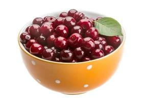 Cherry in the bowl on white background photo