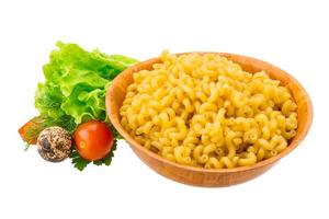 Fusilli pasta in a bowl on white background photo