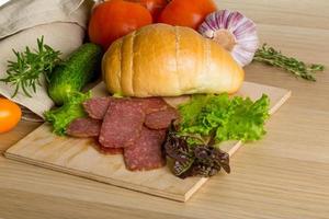 Salami on wooden plate photo