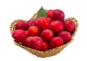 Damson plum in a basket on white background photo