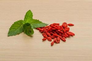 Dry berberis on wooden background photo