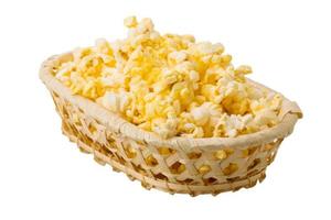 Popcorn in a basket on white background photo