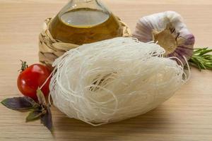 Rice noodle on wooden background photo