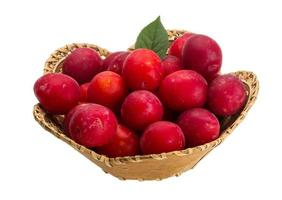 Damson plum in a basket on white background photo