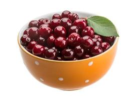 Cherry in the bowl on white background photo