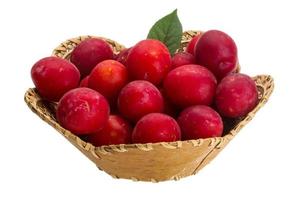 Damson plum in a basket on white background photo