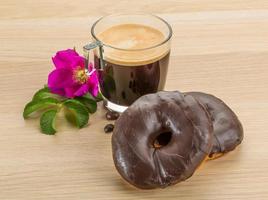 Chocolate donuts on wooden background photo