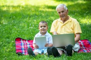 grandfather and child using laptop photo