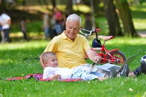 grandfather and child using laptop photo