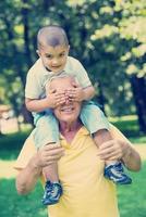 grandfather and child have fun  in park photo