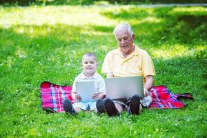 grandfather and child using laptop photo
