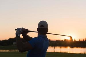 golfer hitting long shot photo