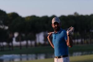 golfer  portrait at golf course on sunset photo