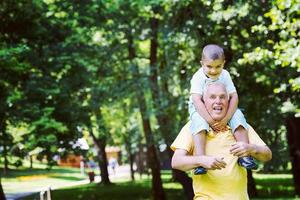 grandfather and child have fun  in park photo