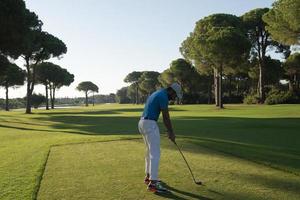 golf player hitting shot photo