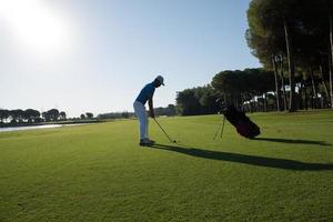 golf player hitting shot photo