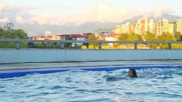 Caucasian woman swim with dolphin in pool. Batumi swim with dolphin experience concept video