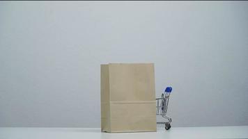 stop motion a cart shopping moving around paper bag. video