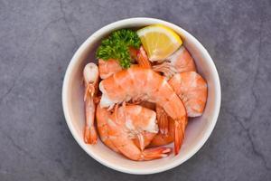 Fresh shrimps served on white bowl, boiled peeled shrimp prawns cooking in the seafood restaurant photo