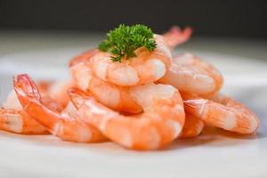 fresh shrimps served on plate - boiled peeled shrimp prawns cooked in the seafood restaurant photo