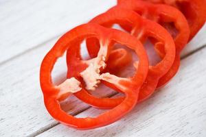 Red pepper bell on wood white background , Top view - bell pepper sliced or fresh sweet pepper photo