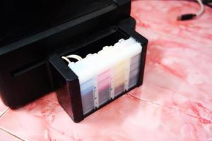 printer ink tank for refill at office - Close up printer cartridge inkjet of color black CMYK , selective focus photo