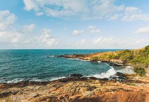 View of sea waves and fantastic rocky coast landscape - Seascape rock tropical island with ocean and blue sky background in Thailand photo